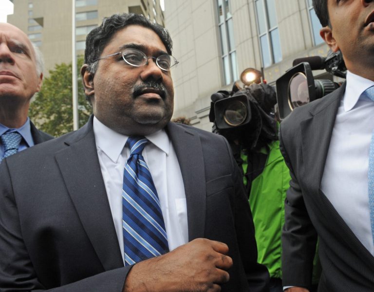 FILE - In this Oct. 13, 2013, file photo, Galleon Group founder Raj Rajaratnam leaves Manhattan federal court following his sentencing, with his attorney Terence Lynam, left, in New York. A former driver and personal assistant to imprisoned hedge-fund founder Rajaratnam says he was asked to help funnel money from his boss to other inmates at a federal prison in Massachusetts. Rajaratnam is serving an 11-year sentence for insider trading at minimum-security Devens Federal Medical Center in Ayer, Mass. (AP Photo/Louis Lanzano, File)
