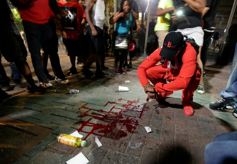 An African-American man was shot at a protest in Charlotte Wednesday night, after residents took to the streets. (AP Photo/Chuck Burton)