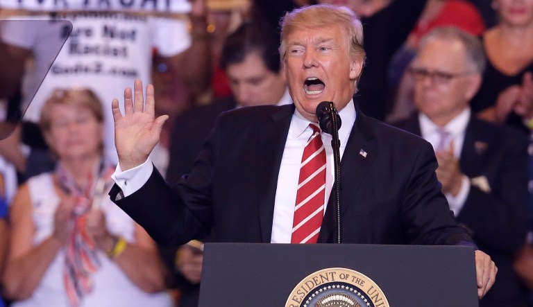 President Donald Trump gestures to the crowd while speaking at a rally at the Phoenix Convention Center, Tuesday, Aug. 22, 2017, in Phoenix. (AP Photo/Rick Scuteri)