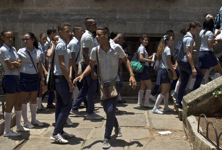 Students come to school for an exam of mathematics at the Pre-University Jose Marti in Old Havana, Cuba, Monday, June 9, 2014. Eight people are under arrest in connection with a scandal involving the illicit sale of university entrance exams, Cuban authorities said Monday, days after thousands of high school students were forced to retake the test. (AP Photo/Franklin Reyes)