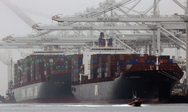 FILE - In this Wednesday, Oct. 23, 2013, file photo, container ships wait to be off loaded in a thick fog in Oakland, Calif. The Commerce Department reports on the U.S. trade deficit for February Thursday April 3, 2014 at 8:30 a.m. EDT. (AP Photo/Ben Margot, File)