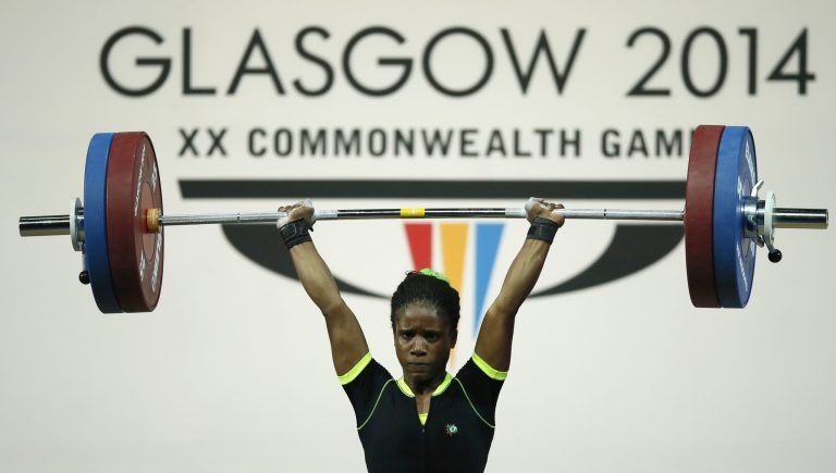 FILE - This is a Friday, July, 25, 2014 file photo  of Chika Amalaha of Nigeria, as she makes good lift during the  women's 53 kg weightlifting competition at the Commonwealth Games Glasgow 2014, in Glasgow, Scotland. Amalaha won the gold medal in the event. The Nigerian weightlifting gold medalist Chika Amalaha has failed a doping test at the Commonwealth Games and has been provisionally suspended from the games. Commonwealth Games Federation chief executive Mike Hooper said Tuesday July 29, 2014 that Amalaha tested positive for diuretics and masking agents after being tested on July 25.  (AP Photo/Alastair Grant, File)