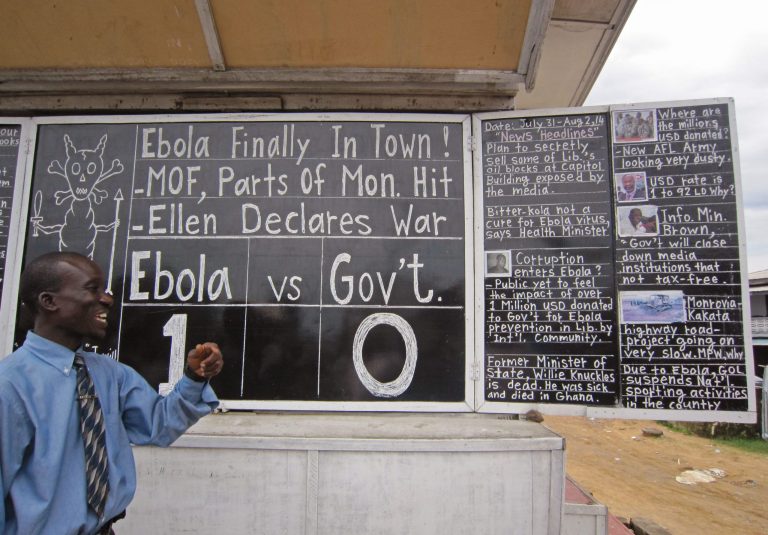 Social Commentator Alfred Sirleaf,  gives comment on current events in Liberia including the deadly Ebola virus by speaking and writhing them down on a blackboard in Monrovia, Liberia, Thursday, July 31, 2014. The worst recorded Ebola outbreak in history surpassed 700 deaths in West Africa as the World Health Organization on Thursday announced dozens of new fatalities. (AP Photo/Jonathan Paye-Layleh)