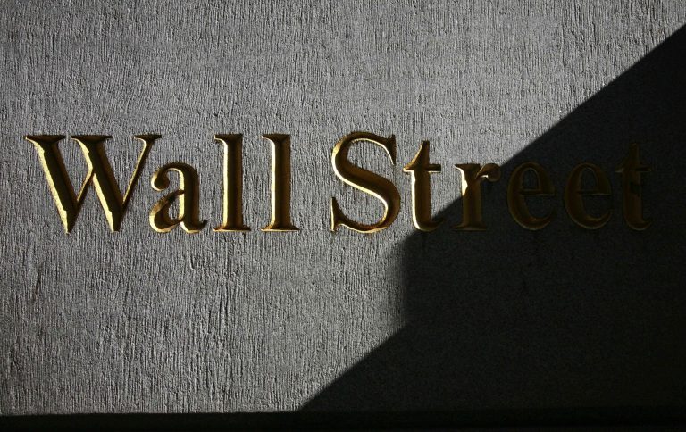 FILE - In this Monday, March 8, 2010, file photo, a sign for Wall Street is shown near the New York Stock Exchange. Global shares were mixed Wednesday Aug. 27, 2014 after the latest record close for the Standard & Poor's 500, with Europe off to a shaky start despite a strong day in Asia. (AP Photo/Mark Lennihan, File)