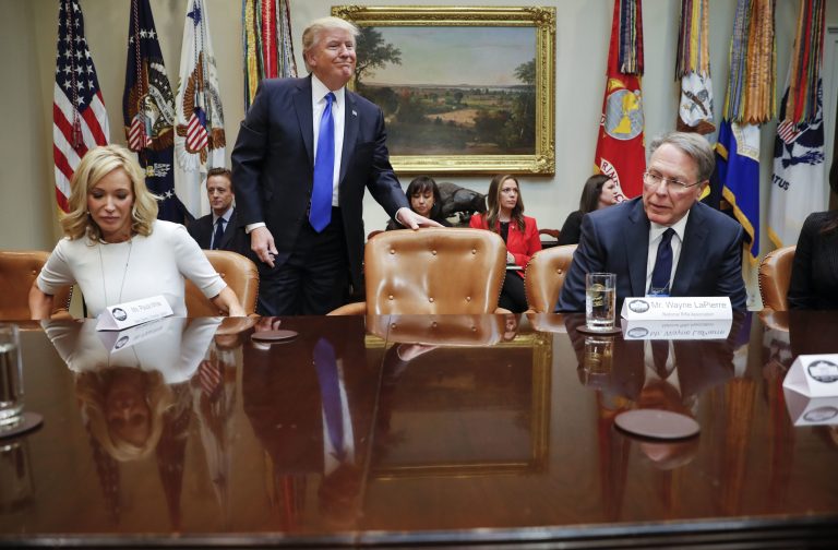 President Donald Trump takes his seat next to National Rifle Associations (NRA) Executive Vice President and Chief Executive Officer Wayne LaPierre, right, and Pastor Paula White of the New Destiny Christian Center, in the Roosevelt Room of the White House in Washington, Wednesday, Feb. 1, 2017. Trump met with a group to discuss the nomination of Neil Gorsuch to the Supreme Court, setting up a fierce fight with Democrats over a jurist who could shape America's legal landscape for decades to come. (AP Photo/Pablo Martinez Monsivais)