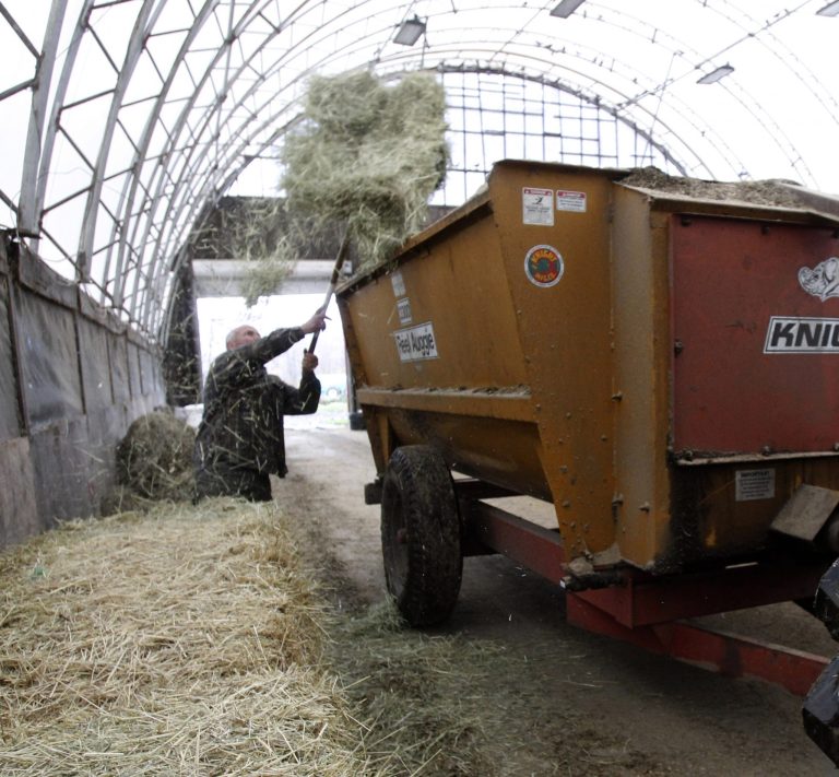  Myles Goodrich loads a feed wagon at his farm in Danville, Vt. (AP/Toby Talbot) 