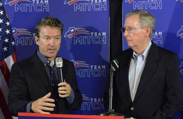 Kentucky Senators Rand Paul, left, and Mitch McConnell address the media during a press conference following McConnell's victory in the republican primary Friday, May 23, 2014, in Louisville, Ky.