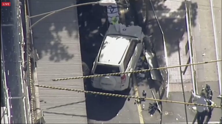 A white SUV vehicle is stopped after allegedly striking pedestrians, Thursday, in Melbourne, Australia. Local media say over a dozen people have been injured after a car drove into pedestrians on a sidewalk in central Melbourne. (Australian Broadcast Corp. via AP)