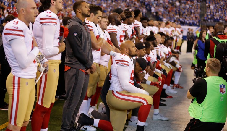 Members of the San Francisco 49ers kneel during the playing of the national anthem before an NFL football game against the Indianapolis Colts on Sunday. (AP Photo/Michael Conroy)
