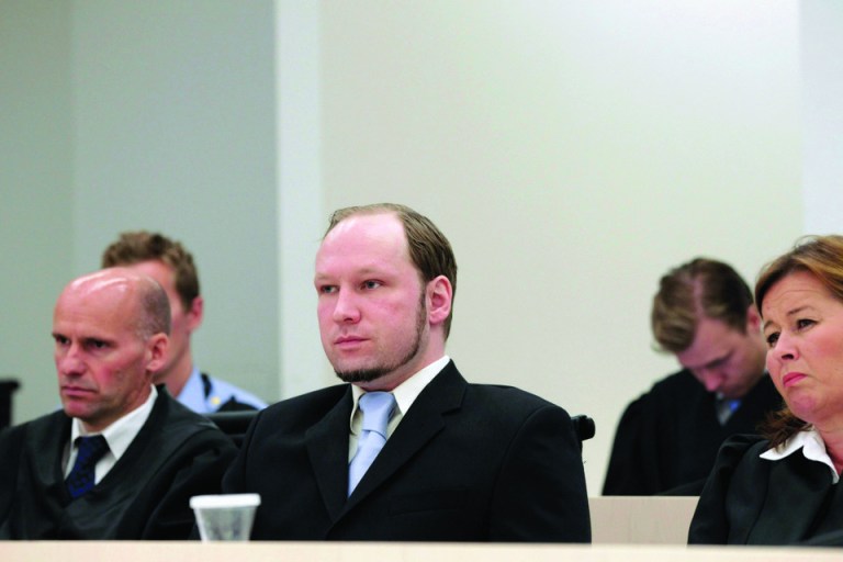 Anders Behring Breivik, the confessed gunman who killed 77 people last year in a bomb and shooting rampage, center, is seated between his defense lawyers Geir Lippestad, left, and Vibeke Hein Baera, right, before prosecutors deliver their closing arguments in the court in Oslo Thursday June 21, 2012. (AP Photo/Berit Roald/Scanpix NTB POOL)