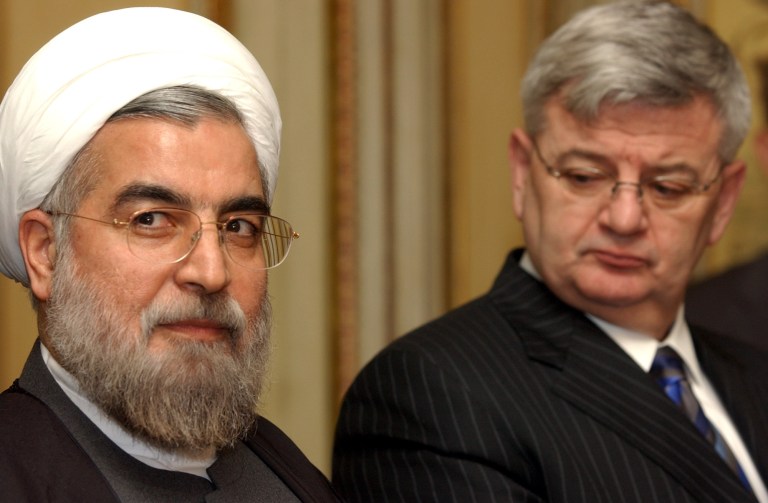 Iran's top nuclear negotiator Hassan Rowhani, left, speaks during a media conference at the British Residence in Brussels, Monday Dec. 13, 2004. Germany, Britain and France launched new negotiations with Iran Monday to seek ways for Tehran to abandon its alleged nuclear weapons program in return for aid to build up its civilian energy program. At right is Germany's Foreign Minister Joschka Fischer. (AP Photo/Virginia Mayo)