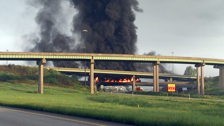 A tanker truck loaded with diesel fuel burns after it overturned along Interstate 81 near Harrisburg, Pa. on Thursday, May 9, 2013, shutting down the heavily traveled artery. The truck was headed northbound from Carlisle shortly after 6 a.m. when it flipped over on a ramp to Route 22-322 westbound, near the I-81 bridge over the Susquehanna River. State police said the driver was treated at a hospital for minor injuries. (AP Photo/TV27-David Tristan)