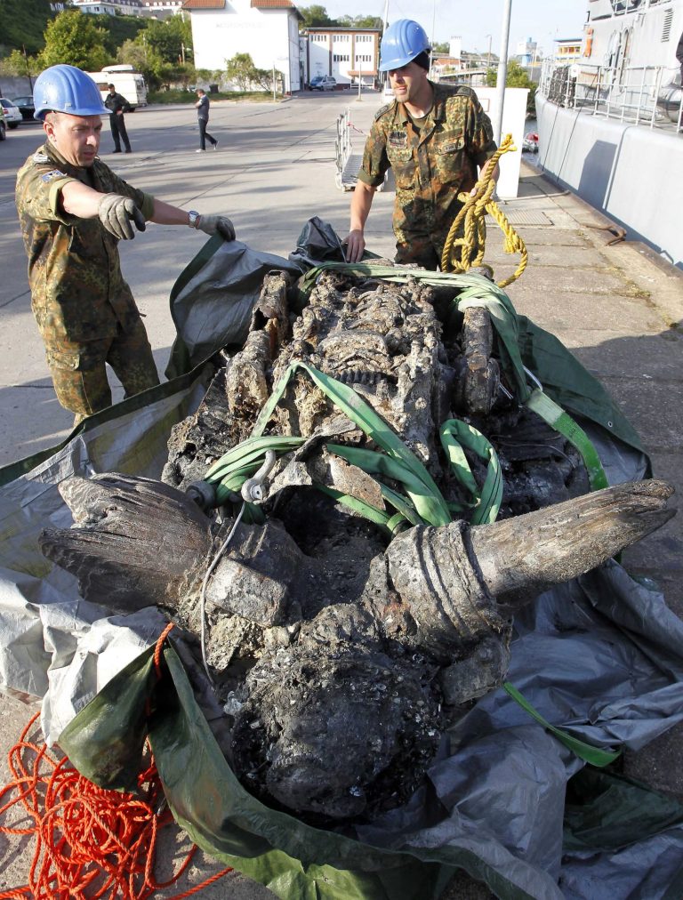   In this photo taken Saturday, June 9, 2012, workers unload the engine of a German Junkers Ju 87 'Stuka' dive bomber from a salvage vessel in Sassnitz, on the Baltic Sea, eastern Germany. A German military museum on Saturday recovered the wreck of a Stuka dive bomber from the floor of the Baltic Sea, a rare remaining example of the plane that once wreaked havoc over Europe as part of the Nazis' war machine. (AP Photo/dapd/Jens Koehler)  