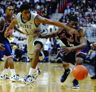 Georgetown's Hollis Thompson (1) and Memphis' Adonis Thomas, right, scramble for a loose ball during second half of an NCAA college basketball game, Thursday, Dec. 22, 2011, in Washington. Georgetown defeated Memphis 70-59. 
