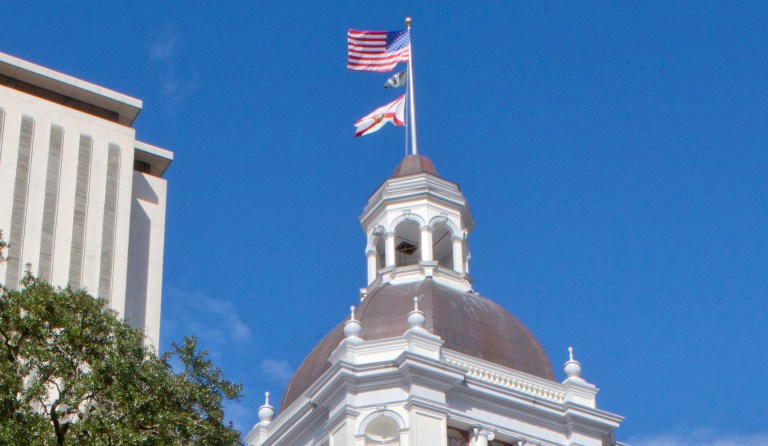 An American flag flies over the Florida Capitol in Tallahassee