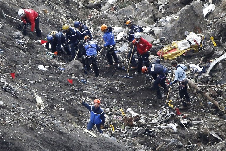 In this Thursday March 26, 2015 file photo, rescue workers inspect the debris from the Germanwings jet at the crash site near Seyne-les-Alpes, France. (AP Photo/Laurent Cipriani, File)