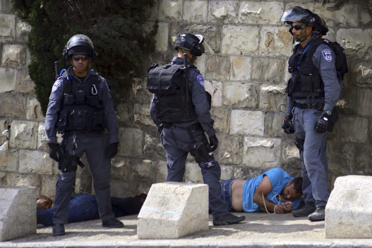 Israeli police officers detain a Palestinian man during clashes near Jerusalem's old city Wednesday, Oct. 15, 2014. Israeli police in riot gear have fired stun grenades to break up a group of Palestinians throwing rocks near sensitive holy sites in Jerusalem's old city ahead of a Jewish festival. The Palestinians were protesting against recent visits by Jews to the site. Palestinians view such visits as a provocation. (AP Photo/Mahmoud Illean)