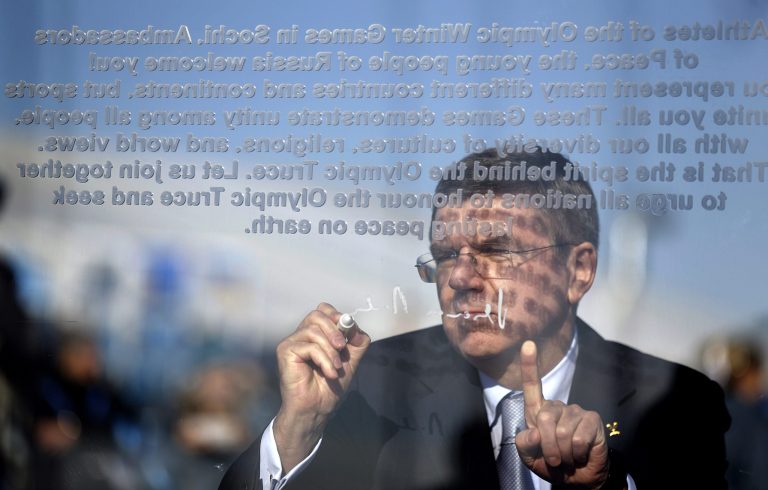 International Olympic Committee President Thomas Bach signs the Olympic truce wall during a ceremony in the Coastal Cluster Olympic Village at the 2014 Winter Olympics, Tuesday, Feb. 4, 2014, in Sochi, Russia. (AP Photo/David Goldman)