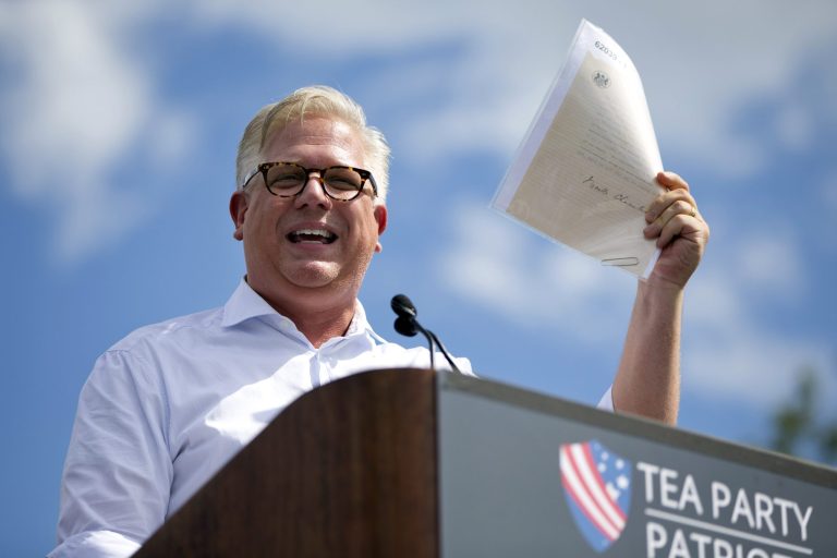 Glenn Beck holds up a document that he said was a WWII era Neville Chamberlain document during his speech during a Tea Party rally against the Iran deal on the West Lawn, of the Capitol in Washington, Wednesday Sept. 9, 2015. (AP Photo/Jacquelyn Martin)