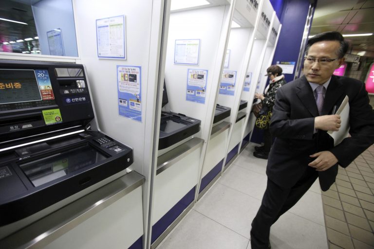A depositor leaves after checking his account through an automated teller machine at a subway station as the bank's computer networks was paralyzed in Seoul, South Korea, Wednesday, March 20, 2013. Police and South Korean officials were investigating the simultaneous shutdown Wednesday of computer networks at several major broadcasters and banks. While the cause wasn't immediately clear, speculation centered on a possible North Korean cyberattack. (AP Photo/Ahn Young-joon)