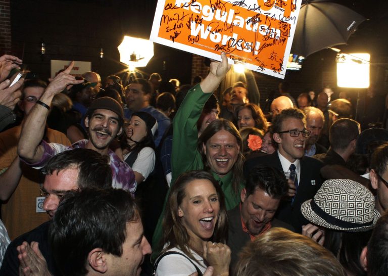   FILE - In this Nov. 6, 2012 file photo, people attending an Amendment 64 watch party celebrate after a local television station announced the marijuana amendment's passage in Denver. Using marijuana for recreational use is now effectively legal in Colorado. Gov. John Hickenlooper declared a voter-approved marijuana legalization amendment as part of the state constitution on Monday, Dec. 10, 2012. It was the last procedural step needed for the amendment to take effect. (AP Photo/Brennan Linsley, File)  
