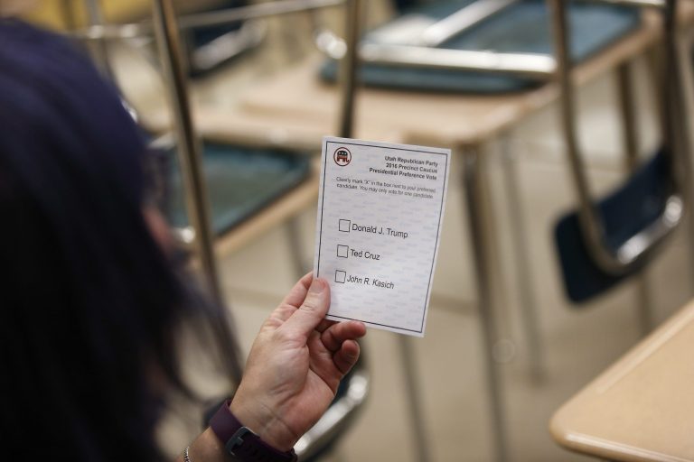 A woman looks at her ballot before voting in a high school classroom at a Republican caucus site Tuesday, March 22, 2016, in Salt Lake City. (AP Photo/John Locher)