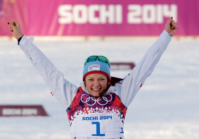 Norway's Maiken Caspersen Falla celebrates winning the gold medal during the flower ceremony for the women's cross-country sprint the 2014 Winter Olympics, Tuesday, Feb. 11, 2014, in Krasnaya Polyana, Russia. (AP Photo/Matthias Schrader)