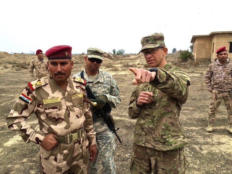 Command Sgt. Maj. Michael A. Grinston, senior trainer for the Combined Joint Forces Land Component Command-Iraq, points out an objective to an Iraqi commander during brigade training at Besmaya, Iraq, on Jan. 29. Grinston, the command's senior enlisted adviser, was visiting Besmaya to observe and improve training of the Iraqi forces. (U.S. Army photo by Master Sgt. Mike Lavigne, 1st Inf. Div. Public Affairs)