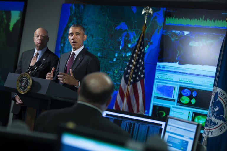 Homeland Security Secretary Jeh Johnson listens at left as President Barack Obama speaks at the National Cybersecurity and Communications Integration Center in Arlington, Va., Tuesday, Jan. 13, 2015. (AP Photo/Evan Vucci)