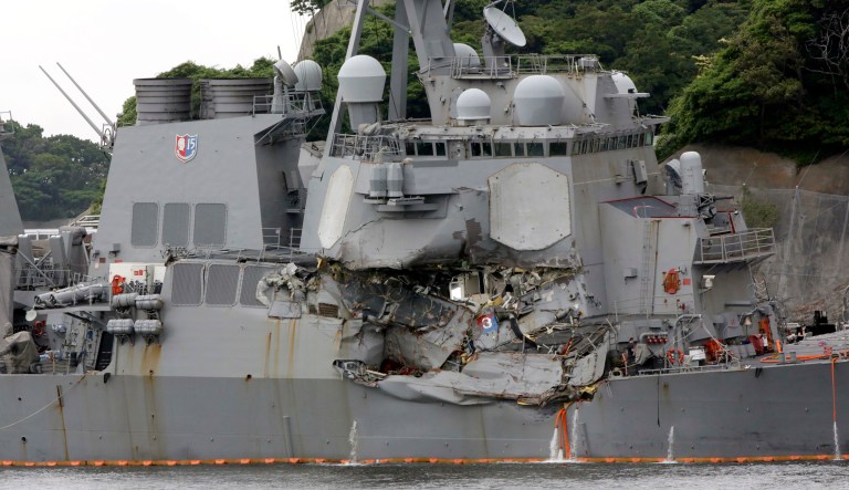 The damaged USS Fitzgerald is docked at the U.S. Naval base in Yokosuka, southwest of Tokyo, after colliding with Philippine-flagged container ship ACX Crystal off Japan. The Navy has removed two senior officials from their posts due to a loss of confidence in their ability to command following the USS John McCain and USS Fitzgerald crashes earlier this summer. (AP Photo/Eugene Hoshiko, File)