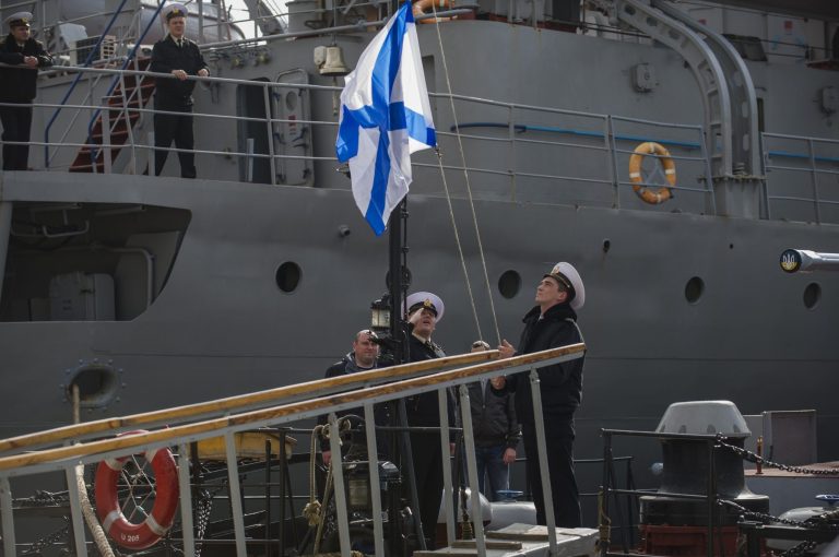 Officers of the Ukrainian navy ship Lutsk raise a Russian navy flag aboard the Lutsk, which has been seized by Russia, in Sevastopol, Thursday, March 20, 2014. Pro-Russian crowds seized two Ukrainian warships Thursday. Shots were fired but there were no casualties as the Ukrainian corvette Khmelnitsky was seized in Sevastopol. Another ship, the Lutsk, was also surrounded by pro-Russian forces. (AP Photo/Andrew Lubimov)