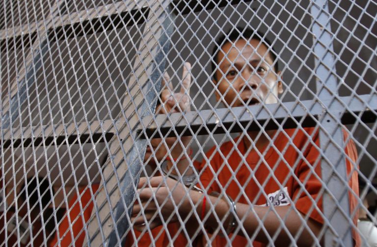 One of the 23 anti-government protesters who had been in prison since being arrested in January, flashes a victory sign on his arrival at Phnom Penh Municipality Court in Phnom Penh, Cambodia, Friday, May 30, 2014. The court has convicted almost two dozen factory workers and rights activists for instigating violence during protests that rocked the government earlier this year. But in a surprise move, the court on Friday gave the 23 defendants suspended sentences of one to 4 and half years in prison, and granted them freedom. (AP Photo/Heng Sinith)