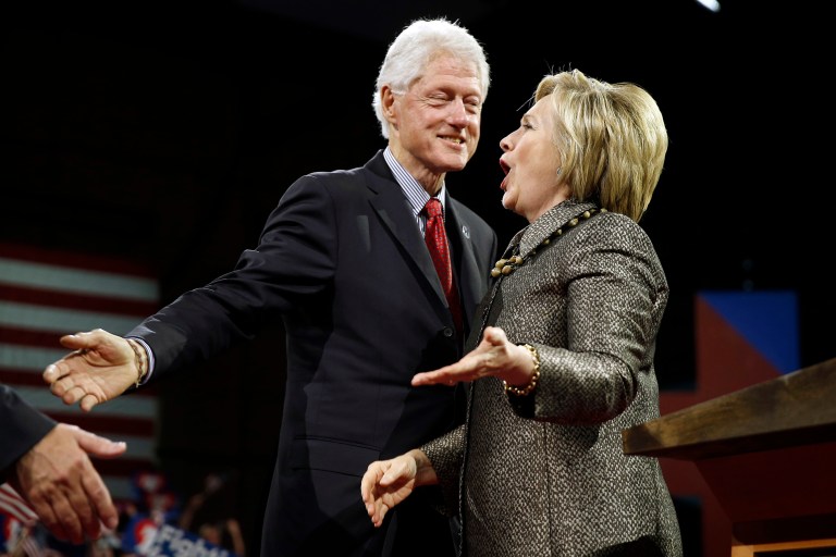 Democratic presidential candidate Hillary Clinton stands with former President Bill Clinton earned over $11 million last year from paid speeches and book royalties. (AP Photo/Matt Rourke)