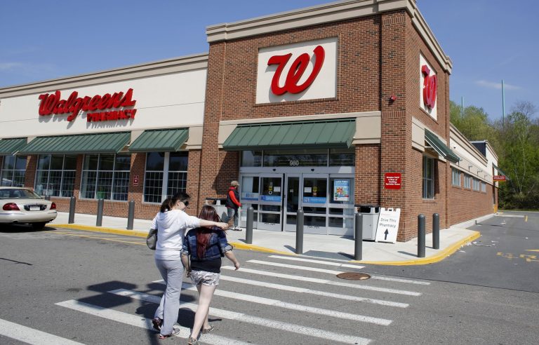 In this Wednesday, May 14, 2014 photo, customers walk toward an entrance to a Walgreens store location, in Boston. Walgreen Co. reports quarterly earnings on Tuesday, June 24, 2014. (AP Photo/Steven Senne)