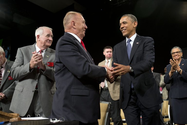 President Barack Obama shakes hands with Disabled American Veterans National Commander Larry Polzin, before speaking in Orlando, Fla., Saturday, Aug. 10, 2013. After the event the Obamas will travel to Martha's Vineyard, Mass. to begin their family vacation. (AP Photo/Jacquelyn Martin)