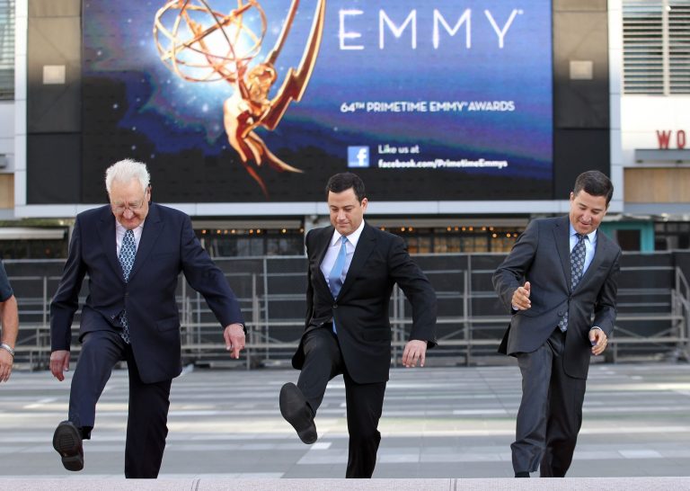 Don Mischer, executive producer of the 64th Primetime Emmy Awards, left, host Jimmy Kimmel, center, and Television Academy chairman and chief executive Bruce Rosenblum attend the Emmy Awards Red Carpet Rollout at the Nokia Theatre in Los Angeles. (AP photo)