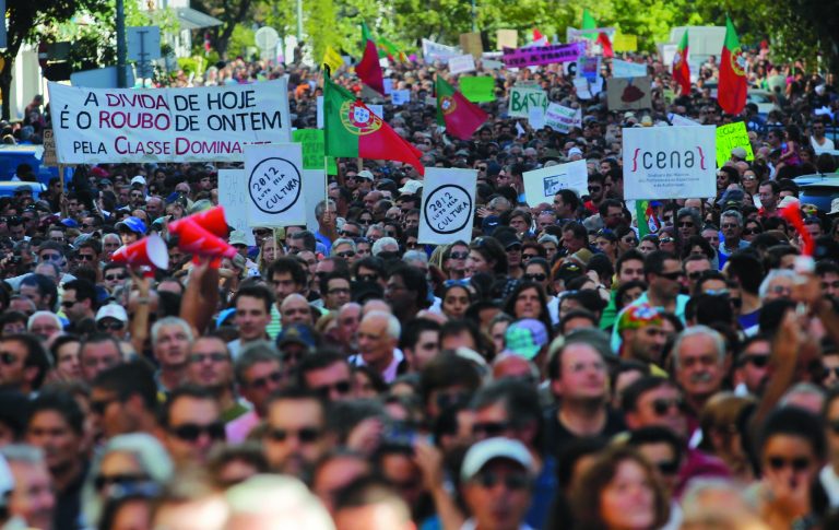 Demonstrators march during a protest against economic austerity measures taken by the Portuguese government linked to a euro 78 billion ($96 billion) bailout needed last year, in Lisbon, Saturday, Sept. 15, 2012. Austerity measures announced in recent days may be the tipping point that transforms the nation's sullen acceptance of belt-tightening into an explosion of anger like that seen in Greece over the past two years. (AP Photo/Francisco Seco)
