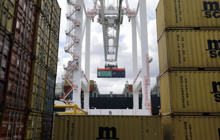 FILE - In this March 1, 2013, file photo, a crane removes a container from a ship at the Port of Baltimore's Seagirt Marine Terminal in Baltimore. The trade gap dropped 12.9 percent in November to $34.3 billion, the Commerce Department said Tuesday, Jan. 7, 2014. That's the smallest monthly trade deficit since October 2009. (AP Photo/Patrick Semansky, File)