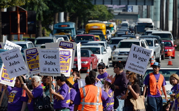 LOS ANGELES, CA - NOVEMBER 21:  Service employees and members from several other unions march on the main thoroughfare to the entrance of Los Angeles International Airport during a large protest a day before Thanksgiving on the busiest travel day of the year November 21, 2012 in Los Angeles, California. (Photo by Kevork Djansezian/Getty Images)