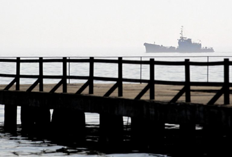 A ship sails by the port of Kerch, Ukraine, Monday, March 3, 2014. Pro-Russian troops controlled a ferry terminal on the easternmost tip of Ukraine's Crimea region close to Russia on Monday, intensifying fears that Moscow will send even more troops into the strategic Black Sea region in its tense dispute with its Slavic neighbor. (AP Photo/Darko Vojinovic)