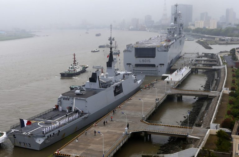 Dixmude, background, the third French Mistral-class amphibious assault ship, and French stealth frigate Aconit dock at Wusong military dockyard, in Shanghai, China, Saturday, May 9, 2015. (Chinatopix via AP)Â 