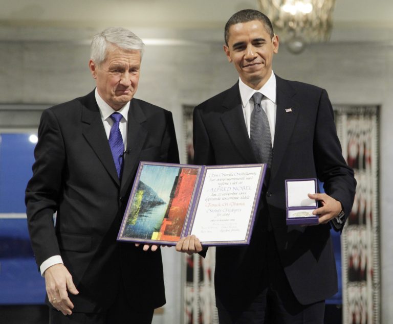 President and Nobel Peace Prize laureate Barack Obama poses with his medal and diploma alongside Nobel committee chairman Thorbjorn Jagland at the Nobel Peace Prize ceremony at City Hall in Oslo, Thursday, Dec. 10, 2009. (AP Photo/John McConnico)