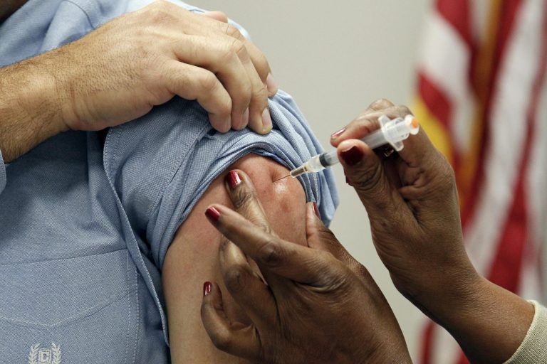   FILE - This Oct. 17, 2012 file photo shows a patient getting a flu shot in Jackson, Miss. Flu vaccination is no longer merely a choice between a jab in the arm or a squirt in the nose. This fall, some brands promise a little extra protection. For the first time, certain vaccines will guard against four strains of flu rather than the usual three. (AP Photo/Rogelio V. Solis, File)  