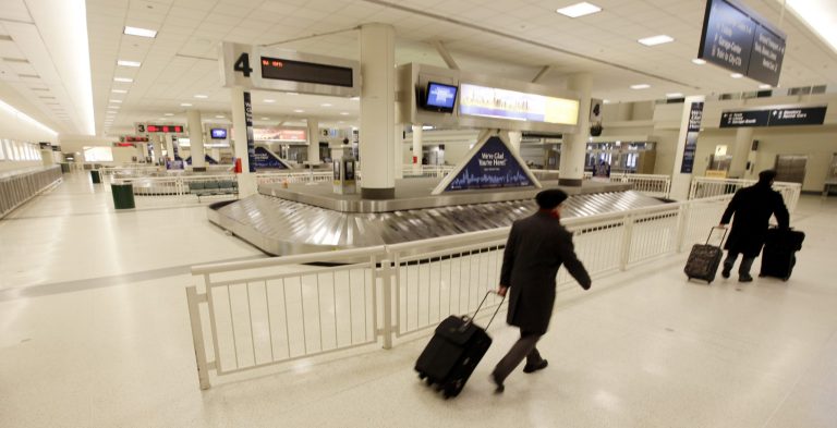 Passengers leave the baggage area at Midway International Airport in Chicago. (AP Photo/M. Spencer Green)