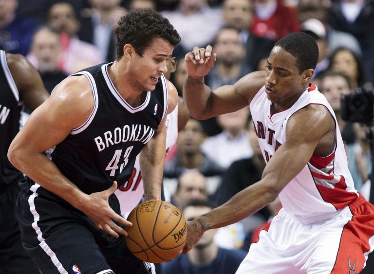   Toronto Raptors forward DeMar DeRozan, right, battles for the ball against Brooklyn Nets forward Kris Humphries, left, during the first half of an NBA basketball game in Toronto, Wednesday, Dec. 12, 2012. (AP Photo/The Canadian Press, Nathan Denette)  