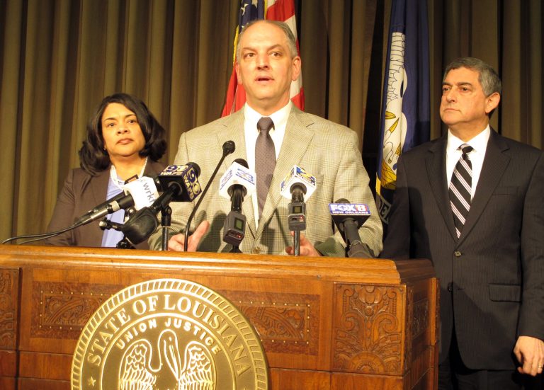 Louisiana Gov. John Bel Edwards, center, unveils his proposals for balancing Louisiana's budget, including a list of tax increases for legislative consideration, during a news conference, Tuesday, Jan. 19, 2016. (AP Photo/Melinda Deslatte)