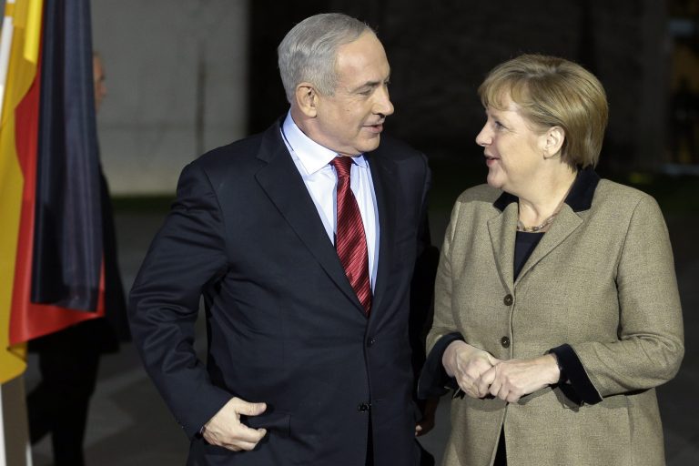   German Chancellor Angela Merkel, right, welcomes the Prime Minister of Israel, Benjamin Netanjahu, in front of the chancellery in Berlin, Germany, Wednesday, Dec. 5, 2012 for a joint dinner prior to intergovernmental talks on Thursday. (AP Photo/Michael Sohn, pool)  