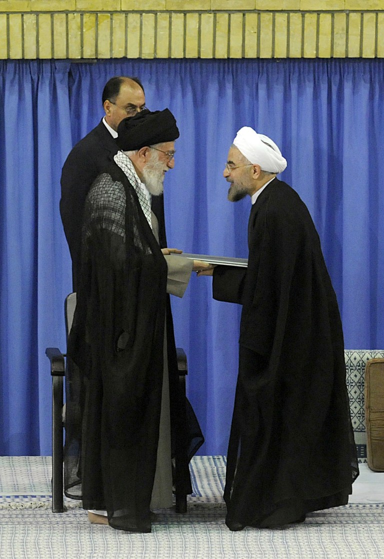   In this picture released by the official website of the Iranian supreme leader's office, Supreme Leader Ayatollah Ali Khamenei, left, gives his official seal of approval to President-elect Hasan Rouhani, in an official endorsement ceremony, in Tehran, Iran, Saturday, Aug. 3, 2013. Iran's supreme leader has formally endorsed Hasan Rouhani as president opening the way for the moderate cleric to take over from outgoing President Mahmoud Ahmadinejad. (AP Photo/Office of the Iranian Supreme Leader)  