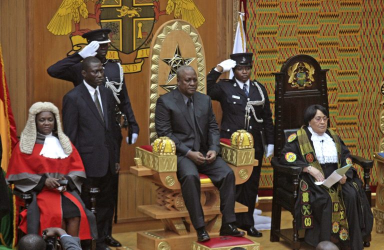   FILE - In this Tuesday, July 24, 2012 file photo, former Vice President John Mahama, center, sits on a dais after being sworn in as new president of Ghana in parliament in Accra, Ghana after the death of President John Atta Mills. After five coups and decades of stagnation, the West African nation of 25 million is now a pacesetter for the continent's efforts to become democratic. In presidential elections on Friday, Dec. 7, 2012, a leading candidate is Mahama, who survived the coups, became president and in fall 2012 published 