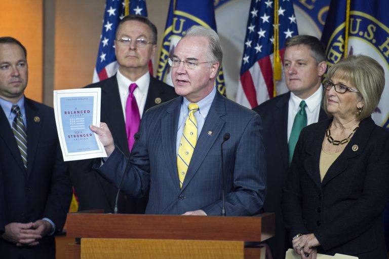 House Budget Committee Chairman Rep. Tom Price, R-Ga., center, holds-up a synopsis of the House Republican budget proposal as he announces the plan on Capitol Hill in Washington, Tuesday, March 17, 2015. (AP Photo/Cliff Owen)
